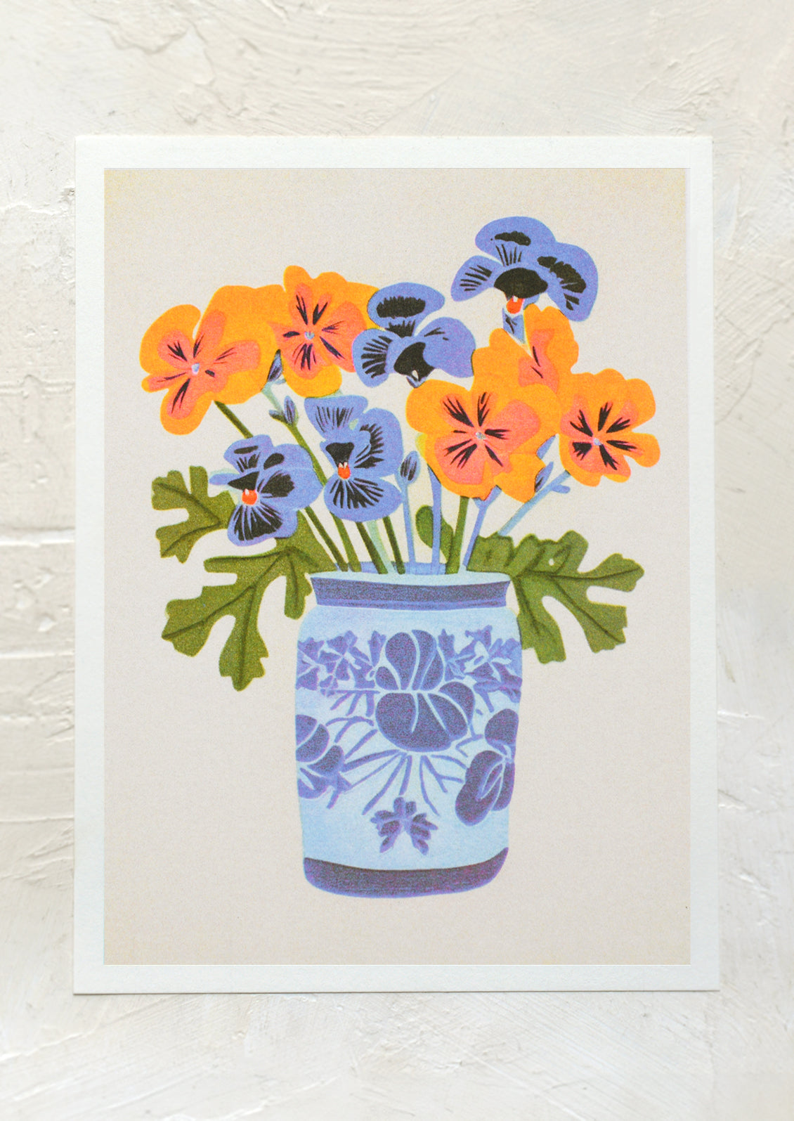An art print of orange and blue pansies in blue vase.