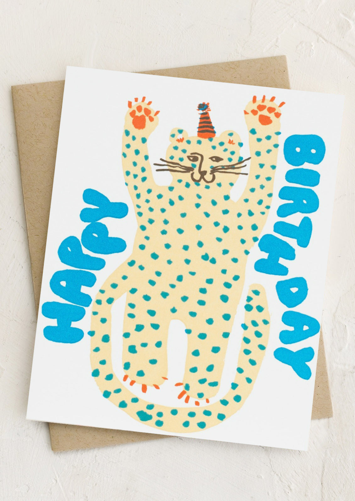 A card with playful image of cheetah wearing party hat, text reads "Happy Birthday".