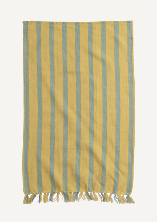 A cotton-linen tea towel in blue and yellow stripe pattern with tassel trim.