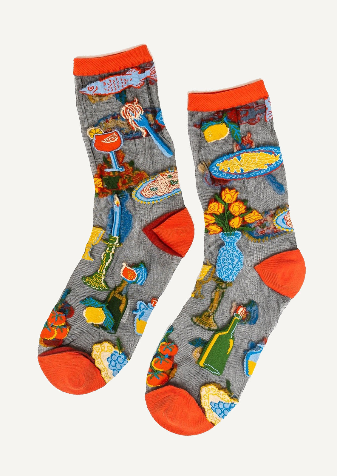 A pair of socks in sheer black with bright red trim, mixed pattern of cocktails, tomatoes, fish etc.