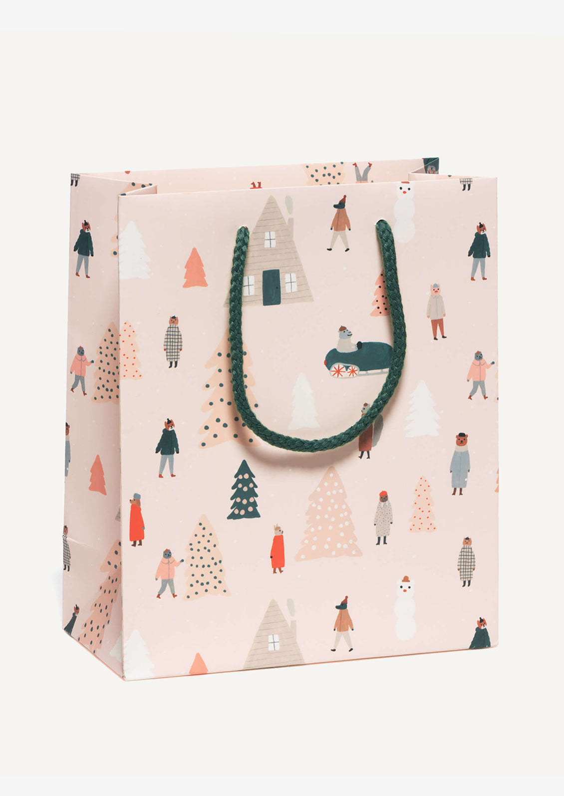 A medium printed gift bag in pale pink with whimsical animal and Christmas tree print.