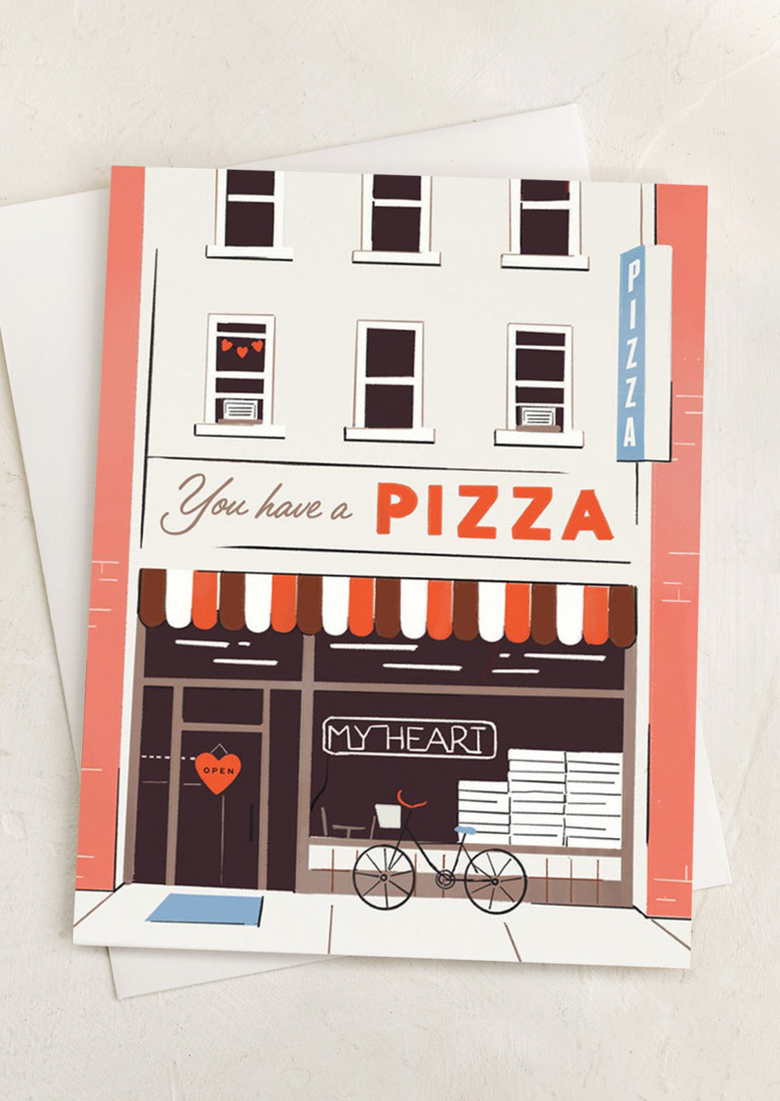 A card with illustration of pizza shop, text reads "You have a pizza my heart".