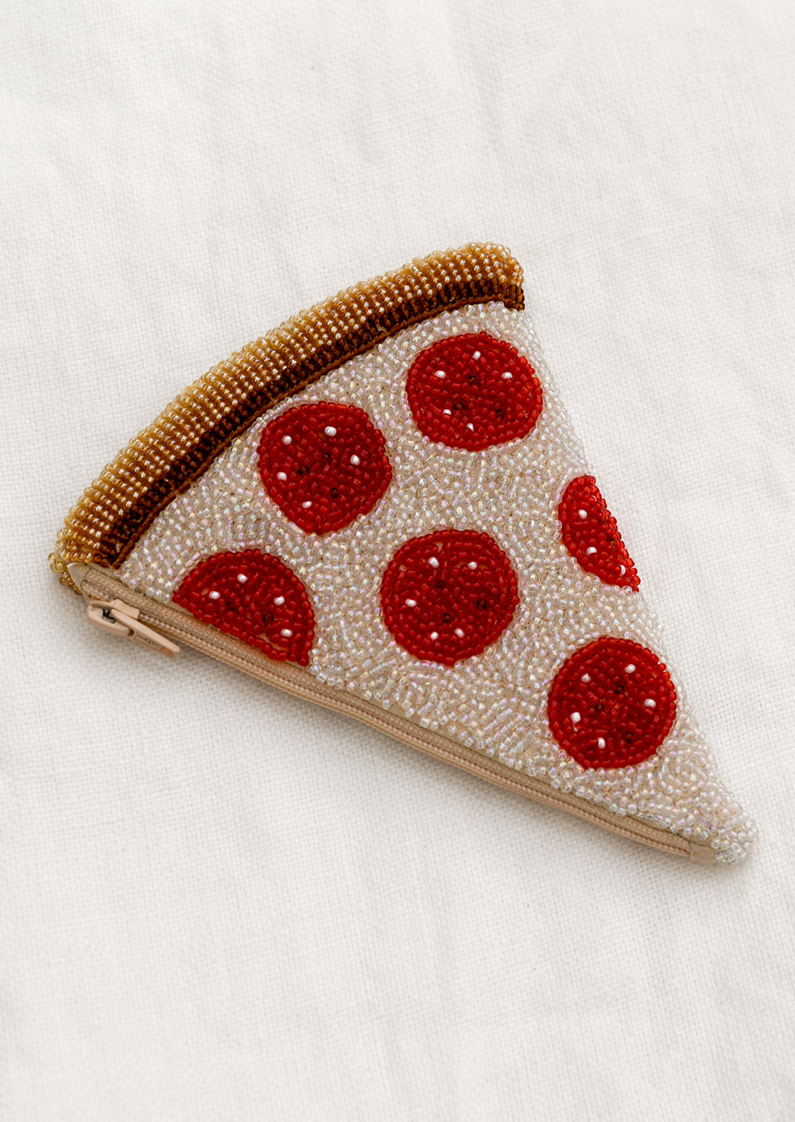 A beaded coin pouch in triangle shape that looks like a slice of pizza.