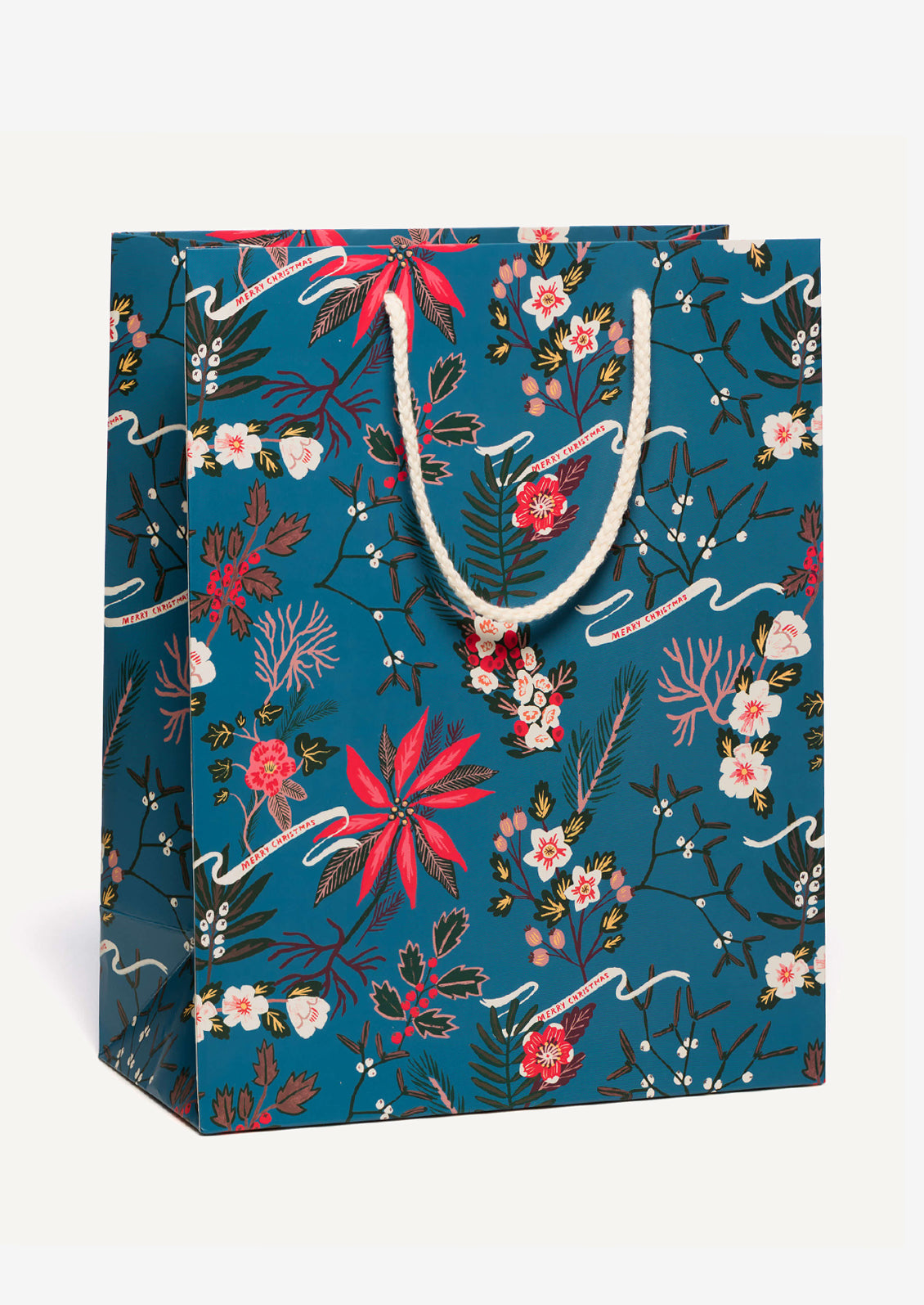 A large printed gift bag in blue with red poinsettia pattern, small lettering reads "Merry Christmas".