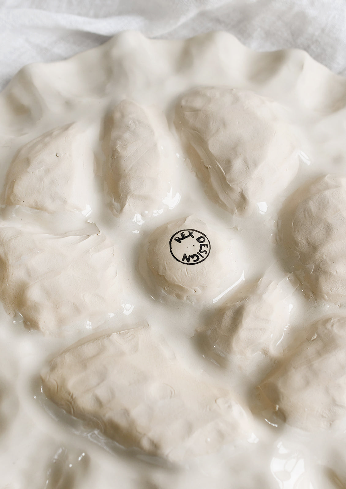 Oyster plate with maker's stamp on bottom.