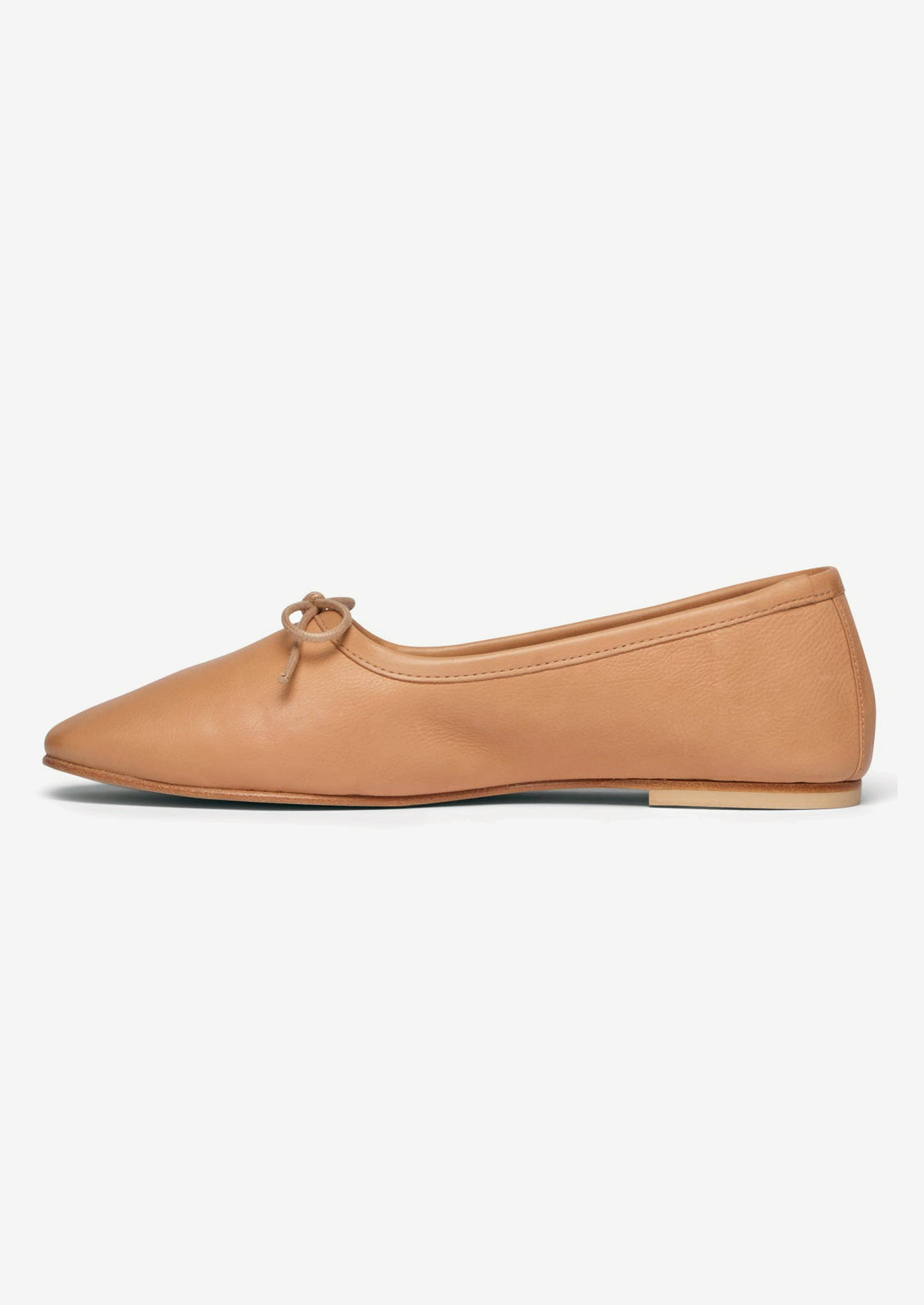 A pair of leather ballet flats with round toe in neutral tan leather.