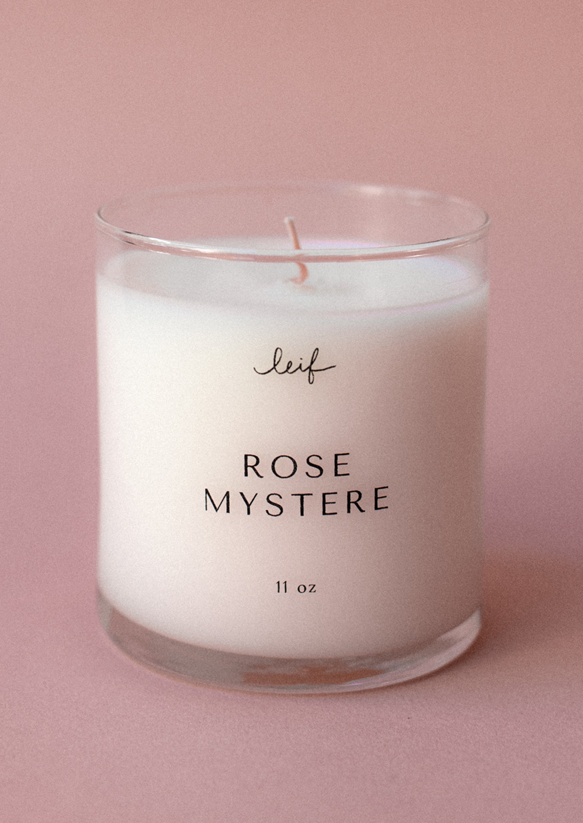 A jar candle in rose mystere scent.