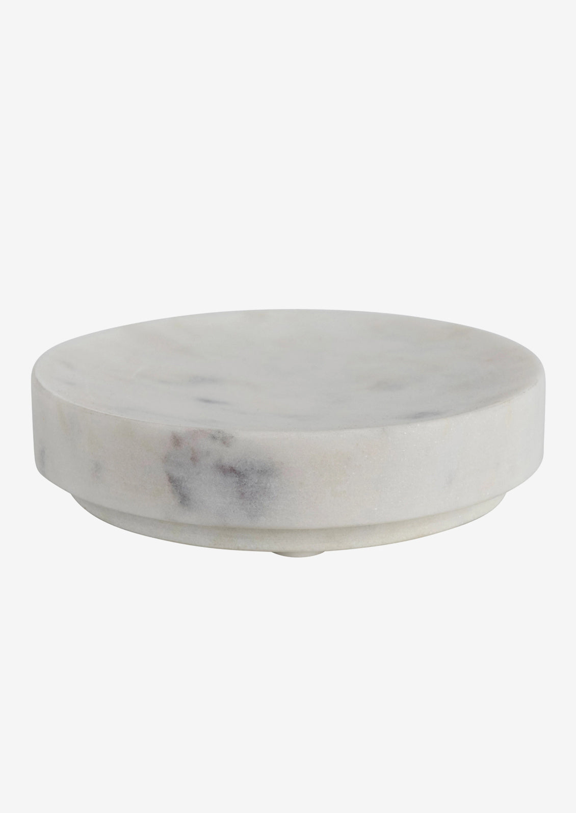 A round soap dish in white marble.
