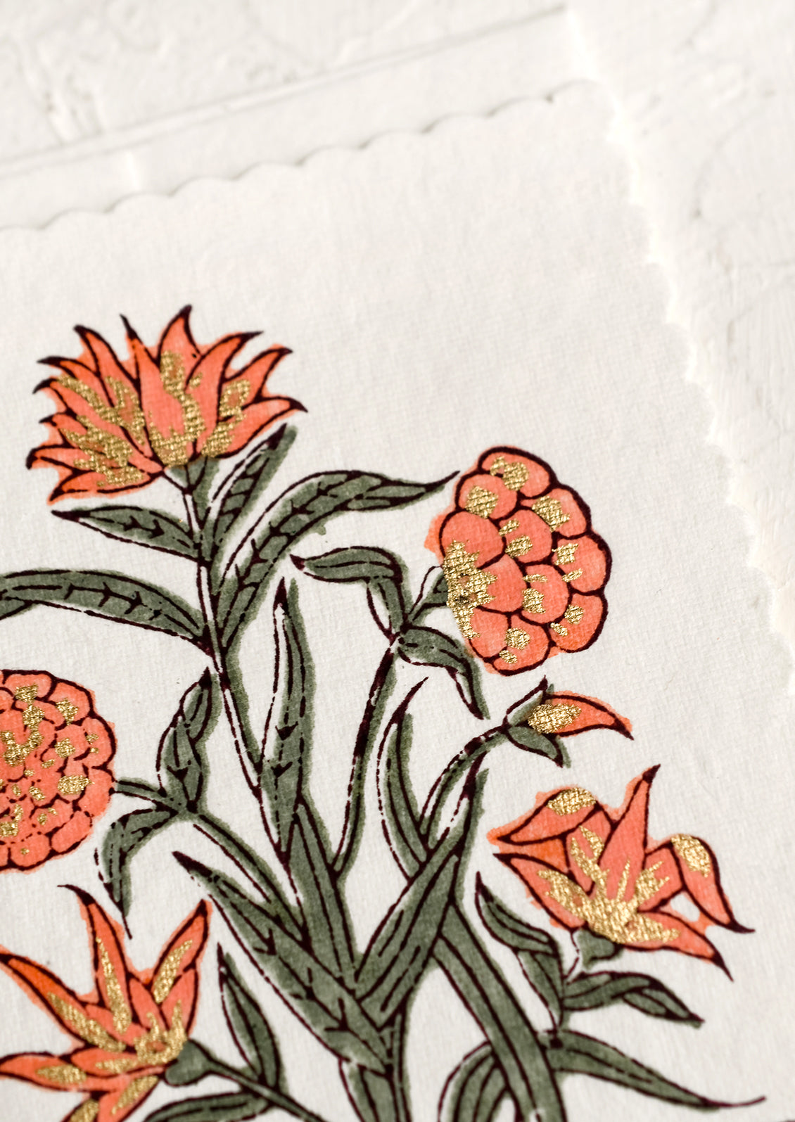 A block printed peach floral card with scalloped edges.