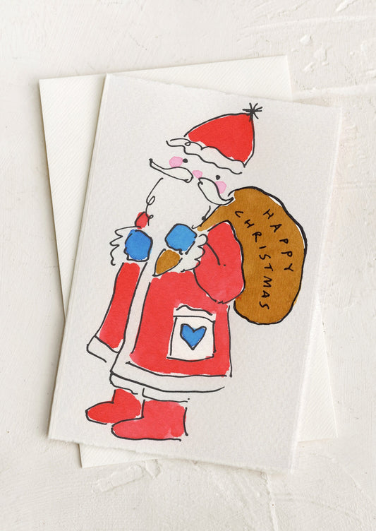 A hand painted greeting card with illustration of santa claus wearing a satchel reading "Happy Christmas".