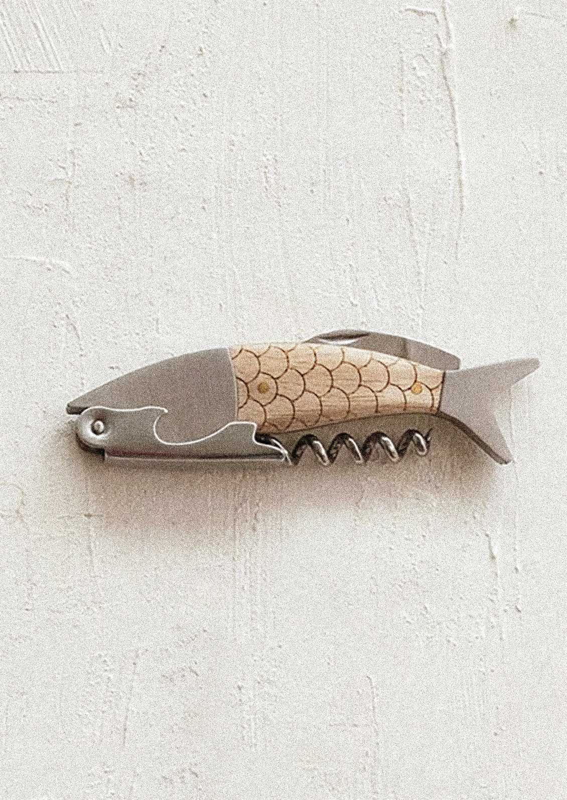 A fish shaped corkscrew/wine bottle opener with oak wood handle.