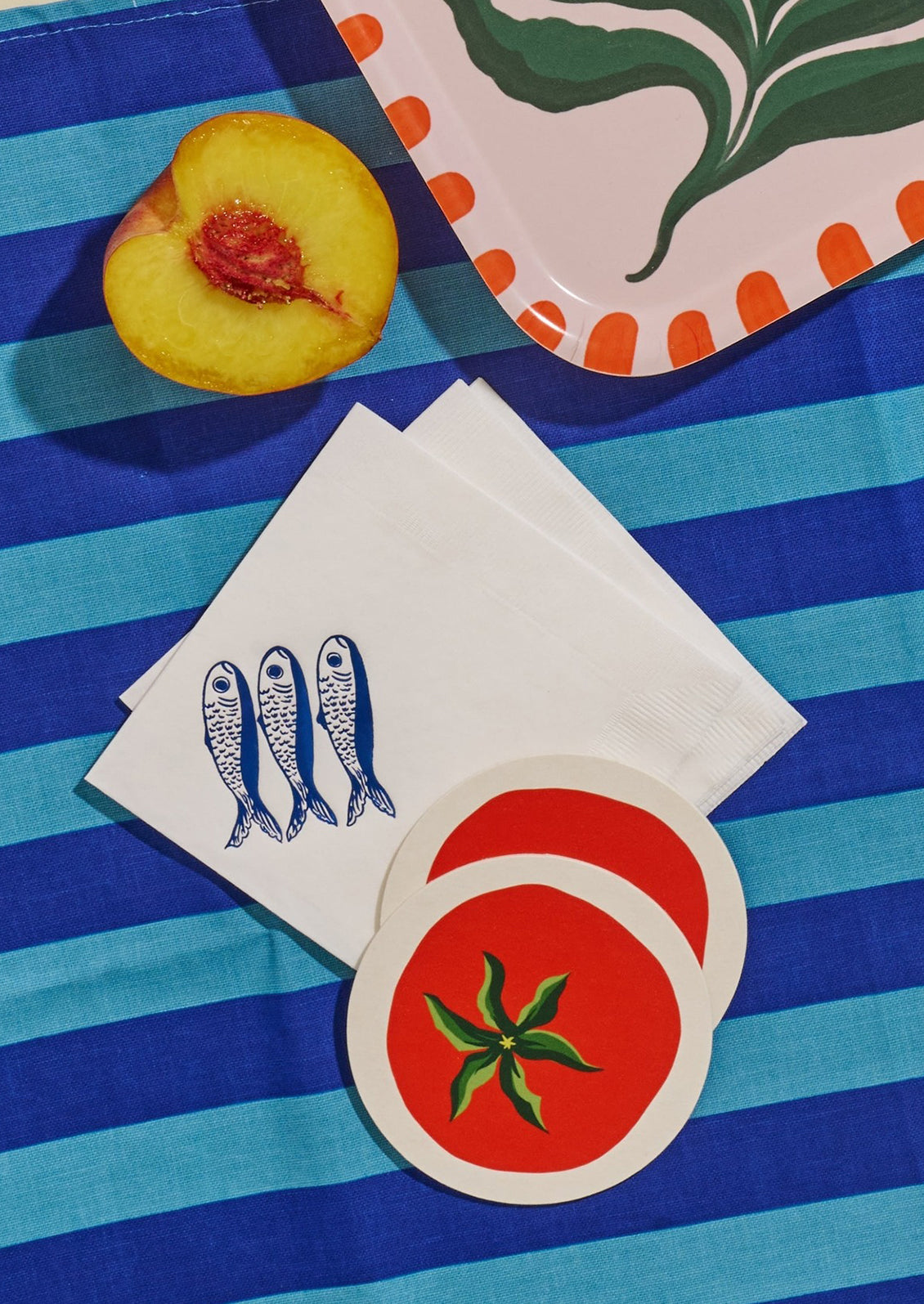 Sardine print paper napkins on table setting.