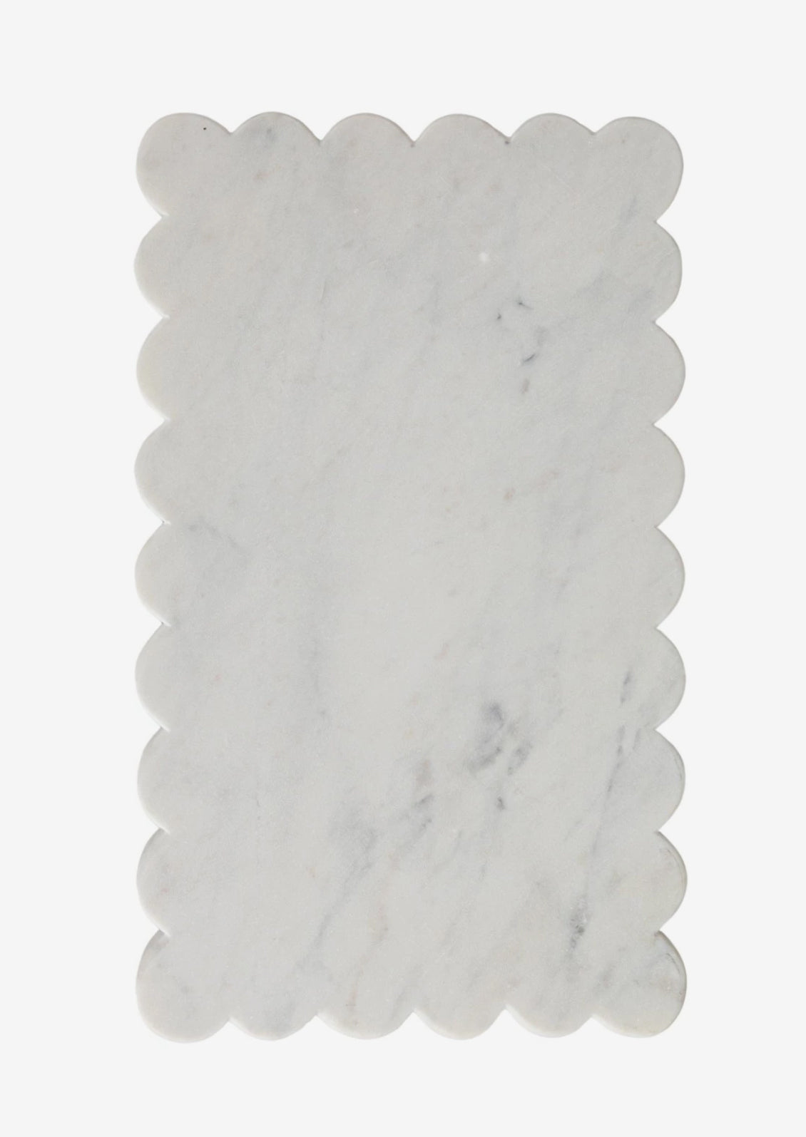 A white marble serving board with scalloped edge.