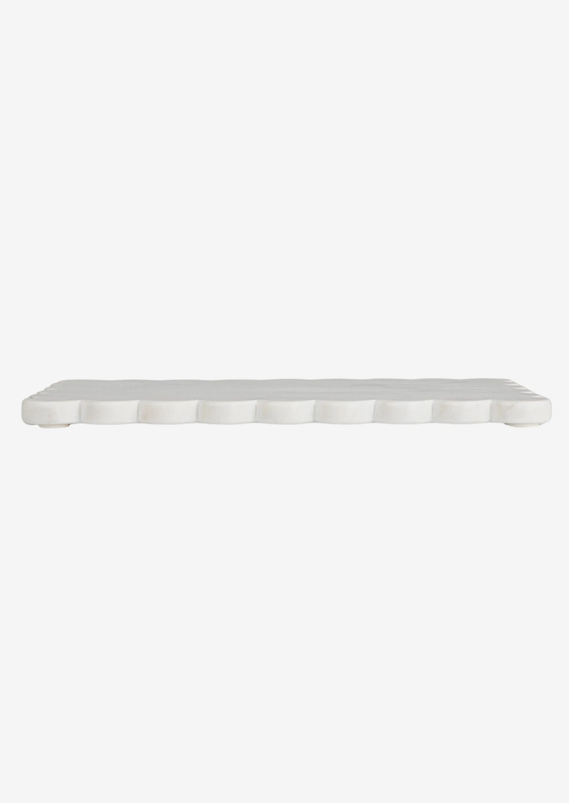 A white marble serving board with scalloped edge.