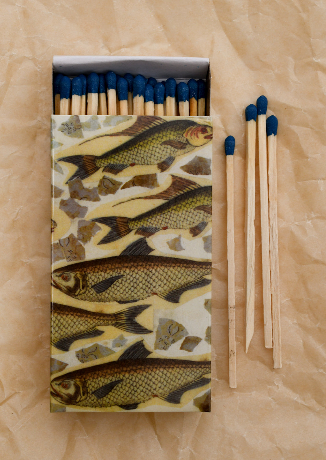 A printed sliding matchbox with school of fish pattern.