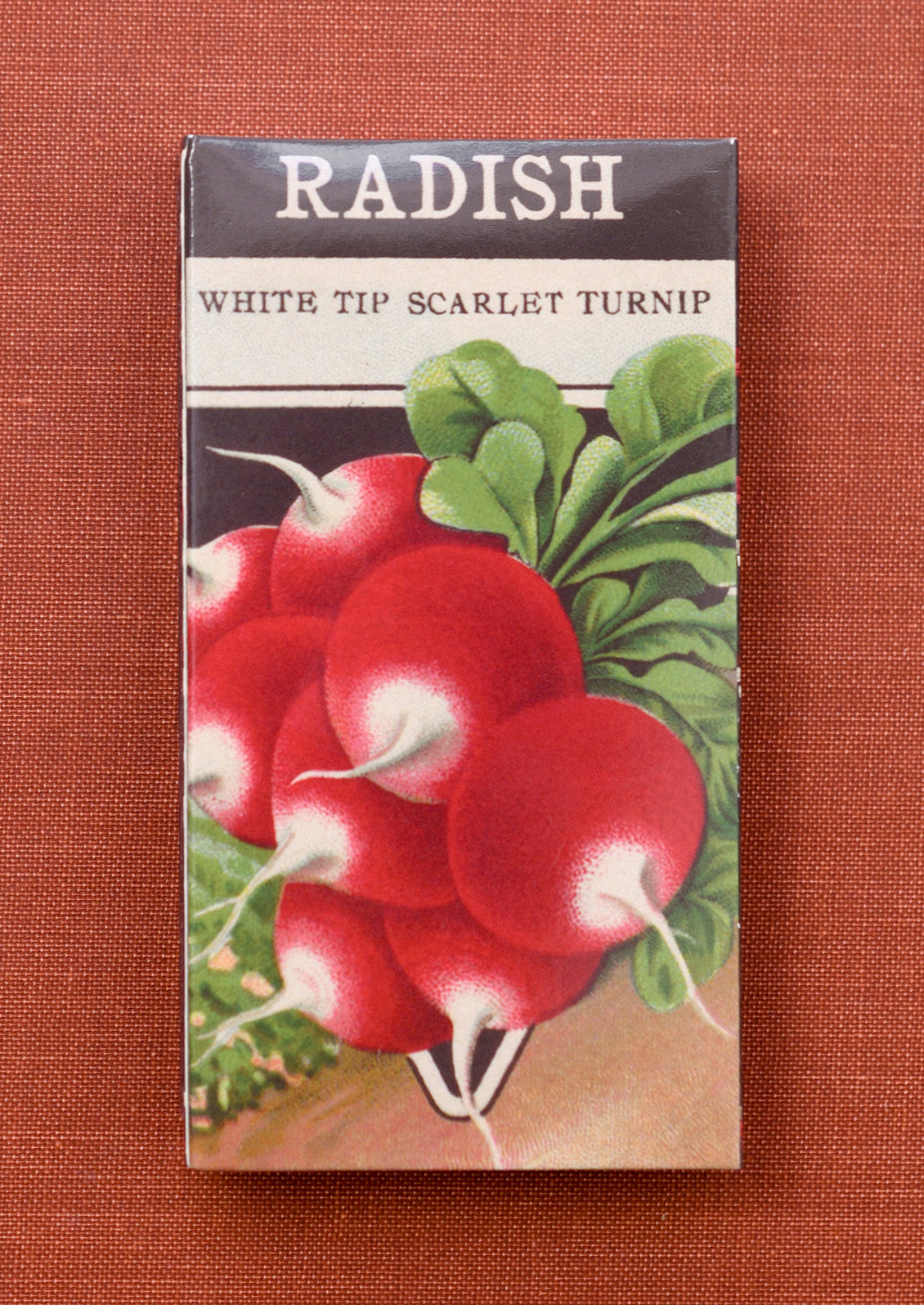 A matchbox with vintage inspired radish seed box print.