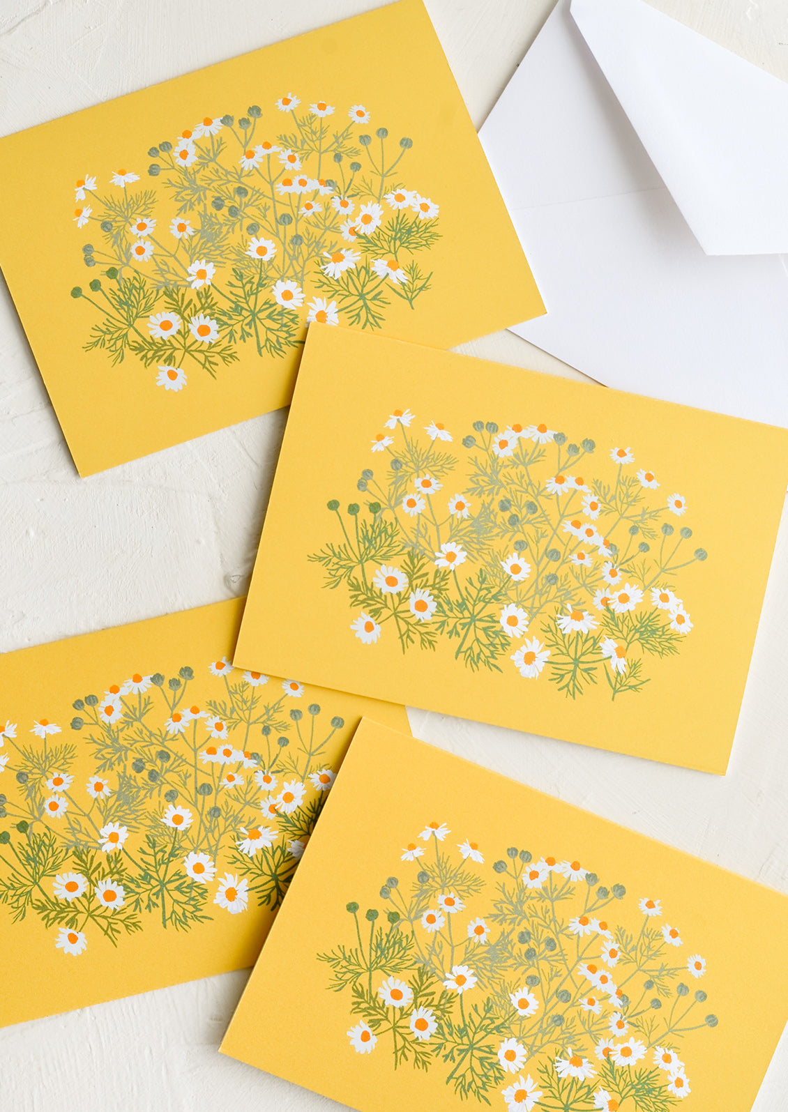 A set of yellow cards with chamomile floral print.