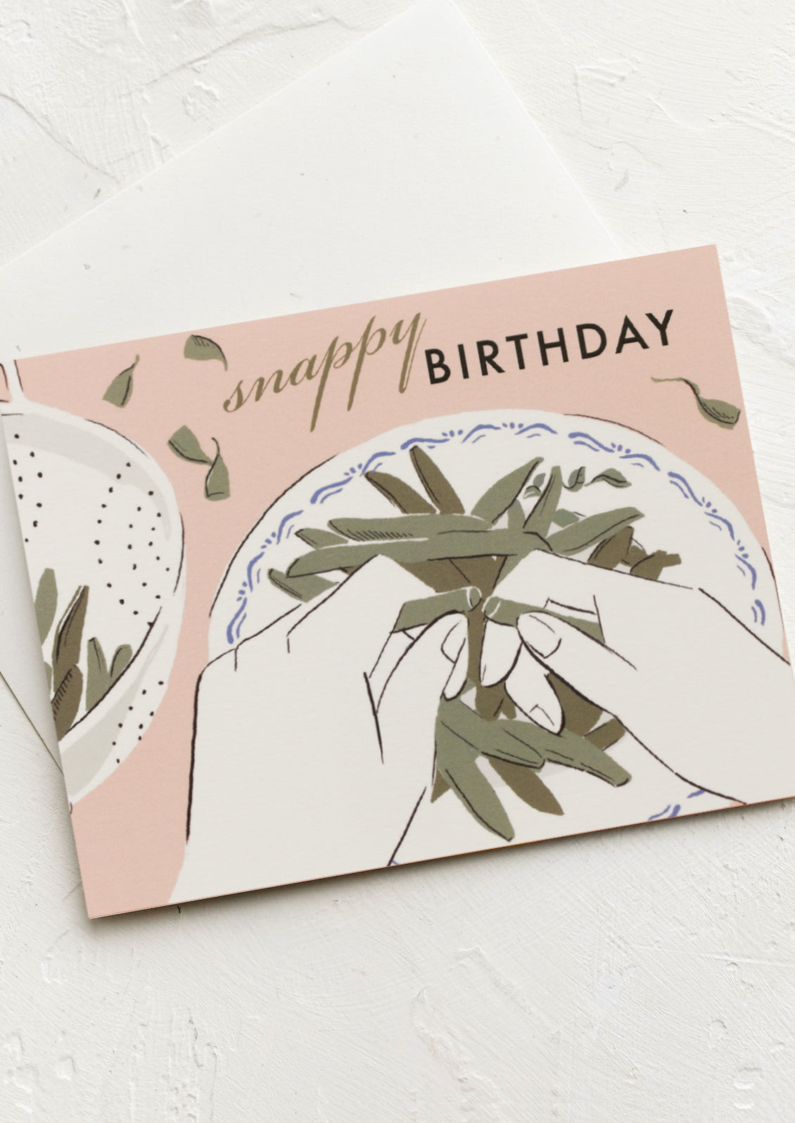 A card with image of hands snapping off green bean ends, text reads "Snappy Birthday".