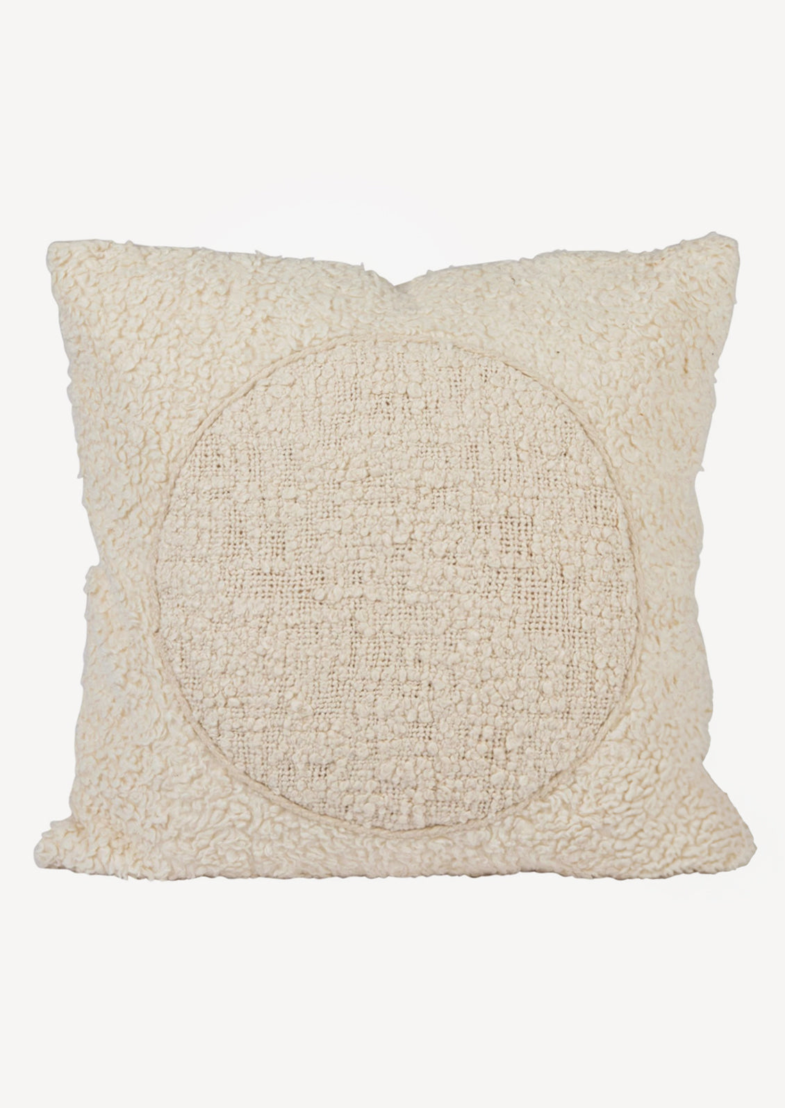 A cream colored throw pillow in soft sherpa material with tonal circle design at center.