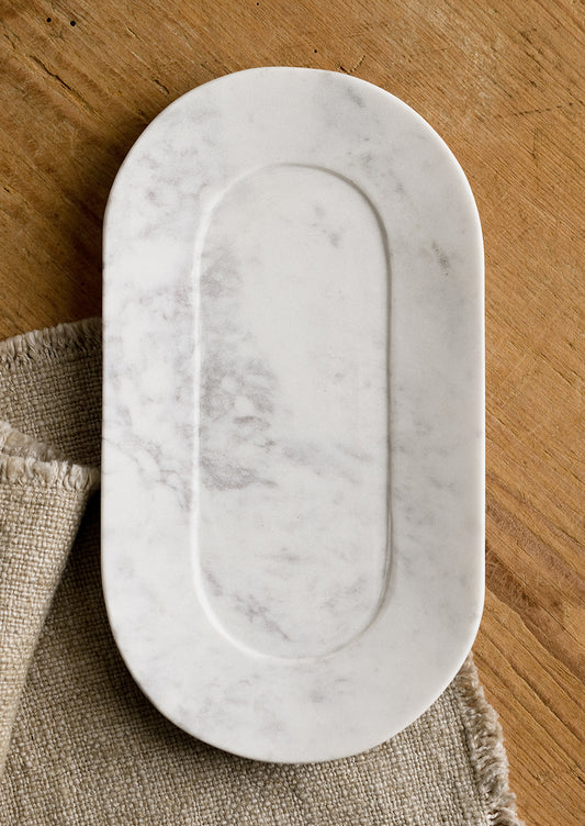 An oval shaped marble catchall tray.