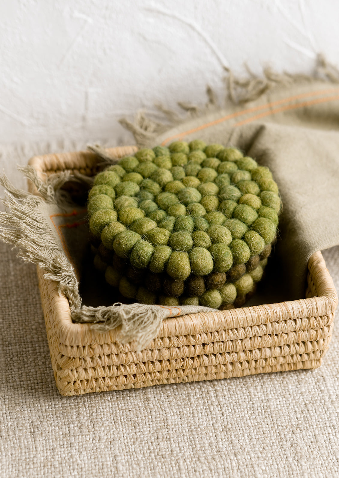 A raffia basket holding coaster set.