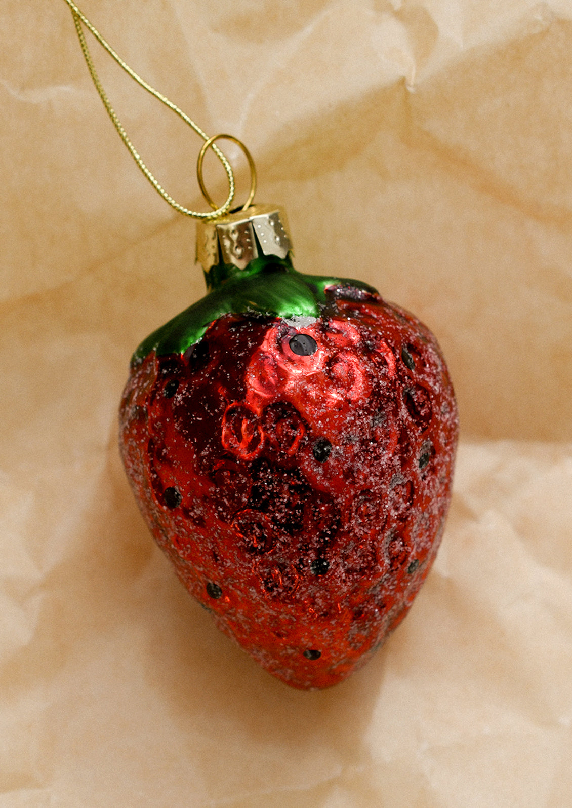 A glass ornament of a strawberry.