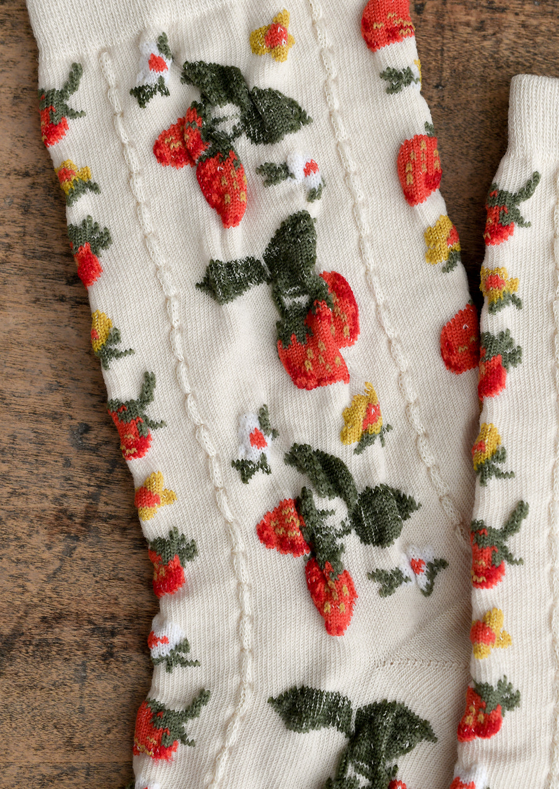 Ivory socks with red, white and yellow strawberry flower print.