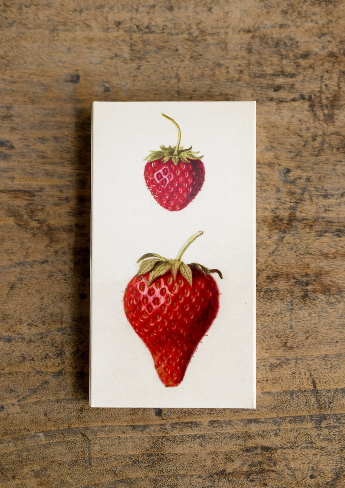 A box of long red tipped matches, box has vintage-inspired strawberry illustration.