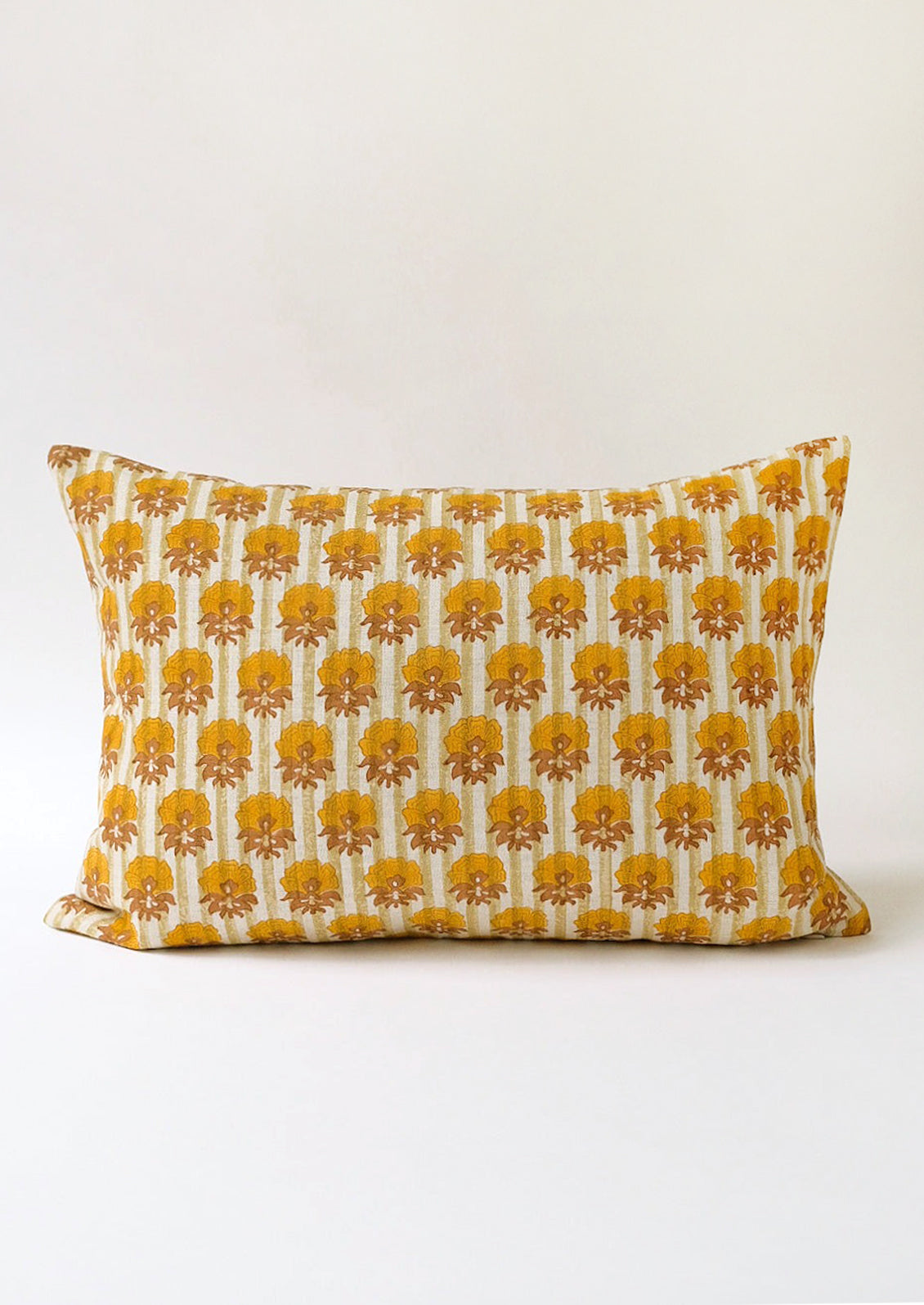 A striped block print pillow with floral print.