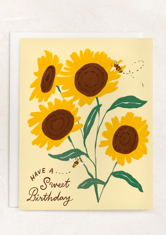 A card with illustration of sunflowers, text reads "Have a Sweet Birthday".