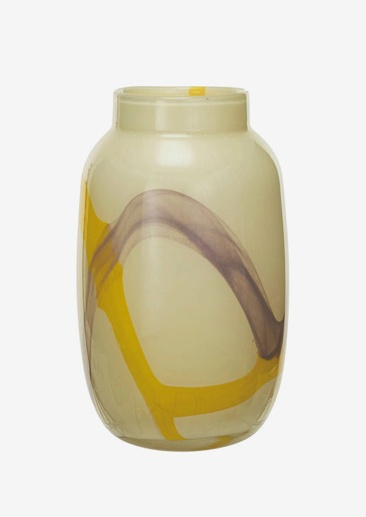 A pale yellow glass vase with bright yellow and lavender paint streaks.