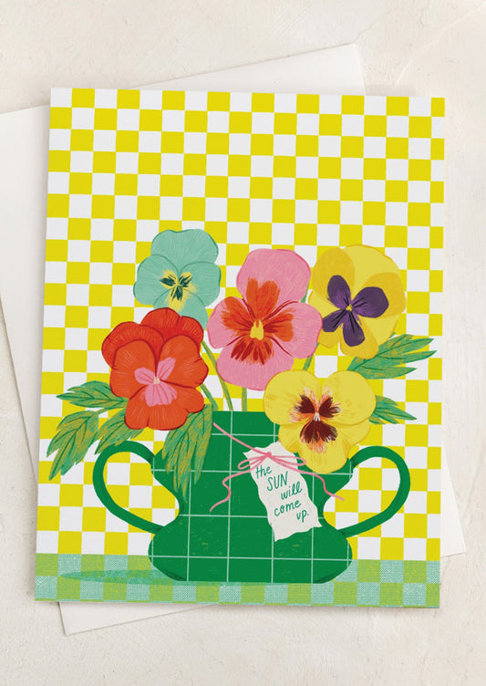 A checkered print card with image of pansies in vase, text reads "The sun will come up".