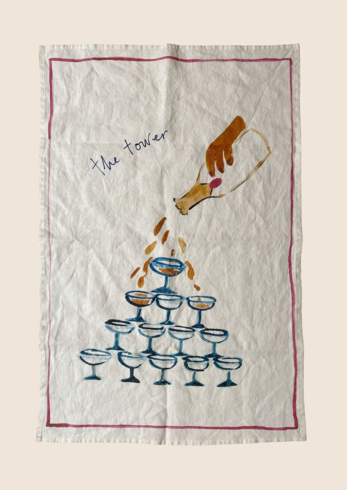 A white linen tea towel with martini tower graphic and text.