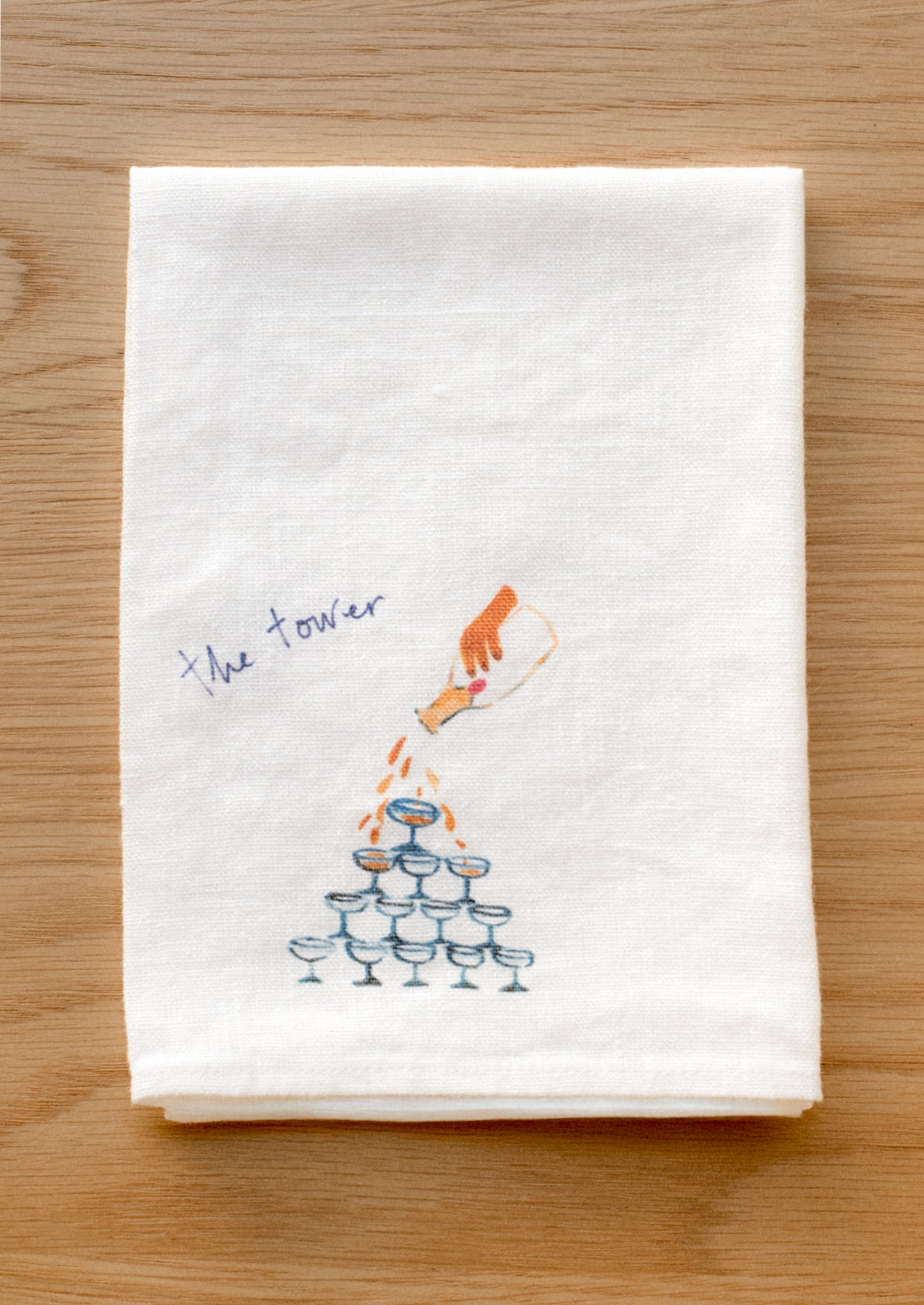 A white linen napkin with graphic detail of tower of cocktails.