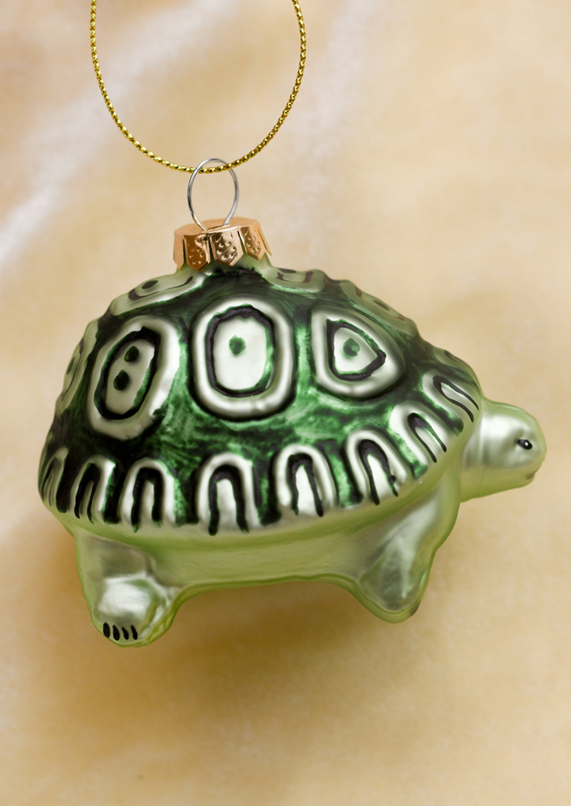 A glass ornament of a green turtle.