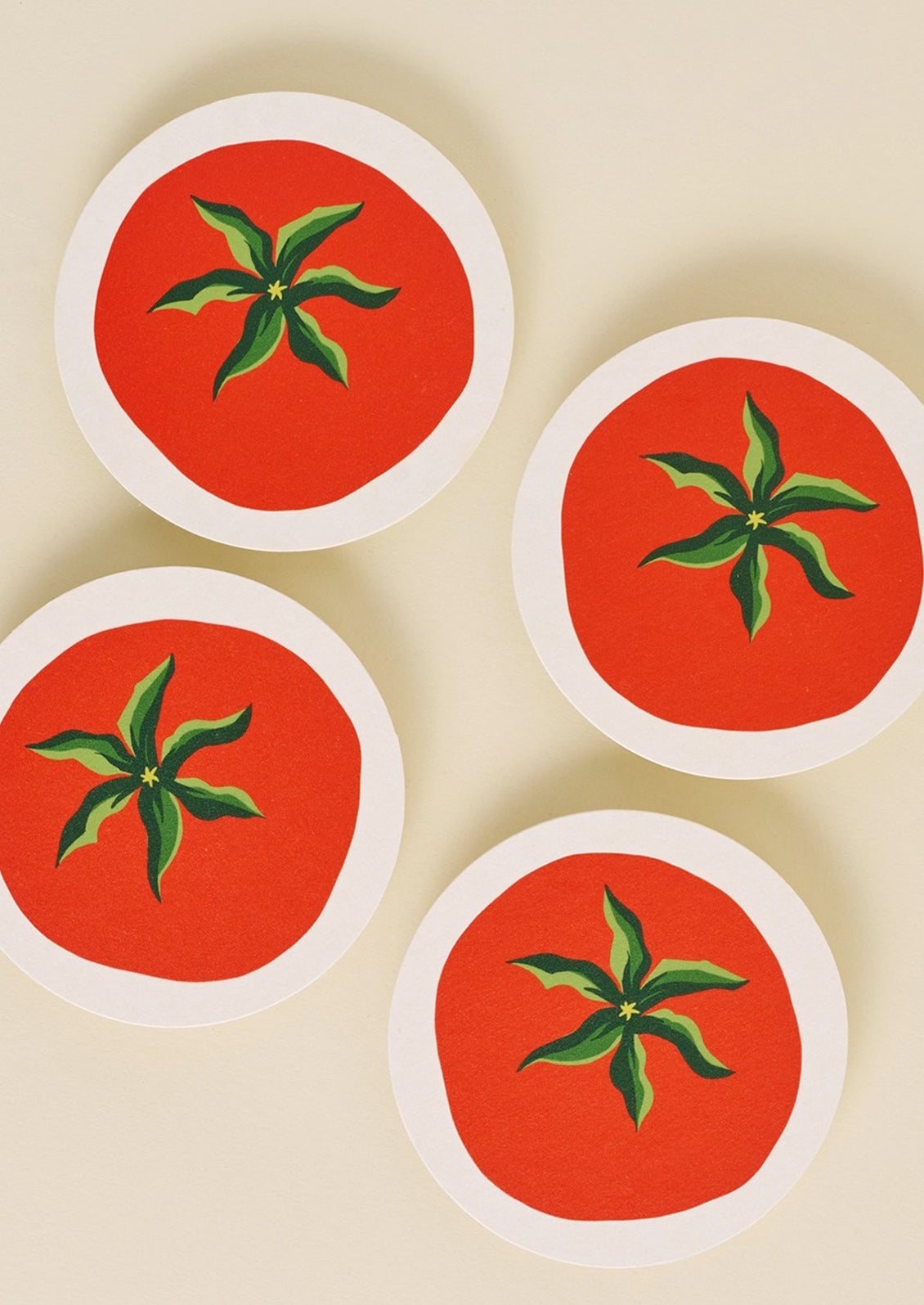 A set of paper coasters in tomato print.