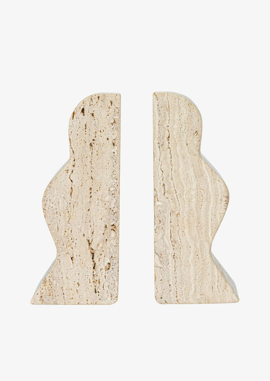 A pair of natural travertine bookends with wavy squiggle shape.