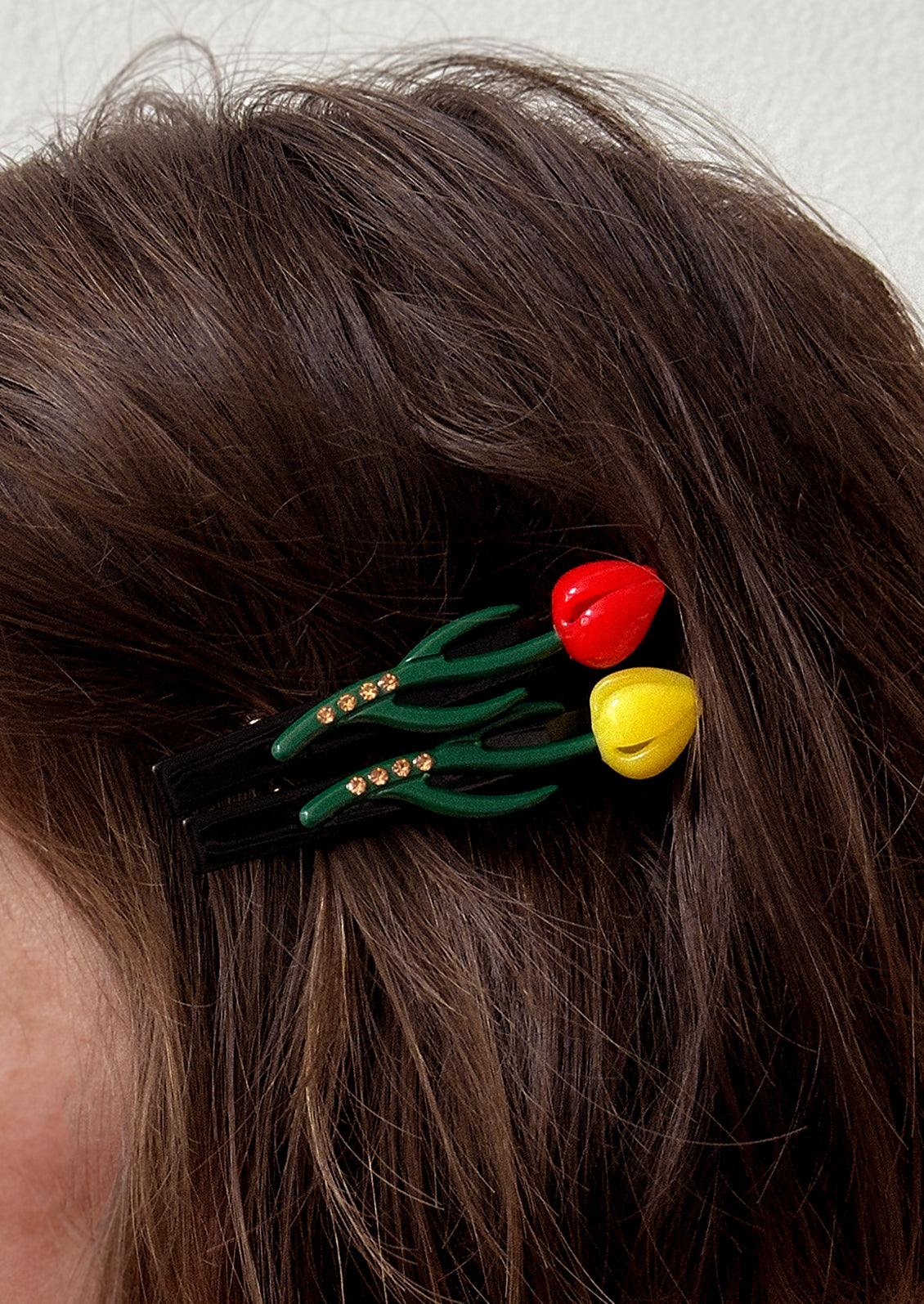 A woman wearing tulip shaped barrettes.