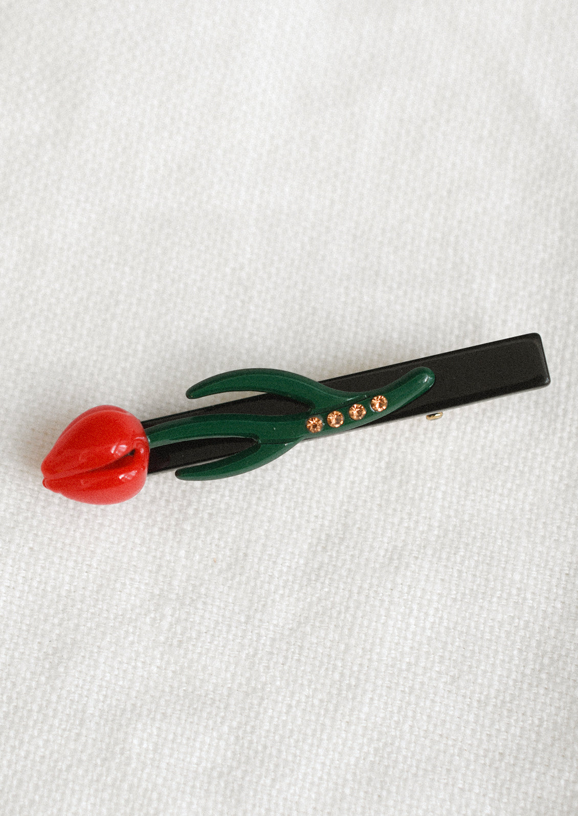 A tulip shaped barrette in red.