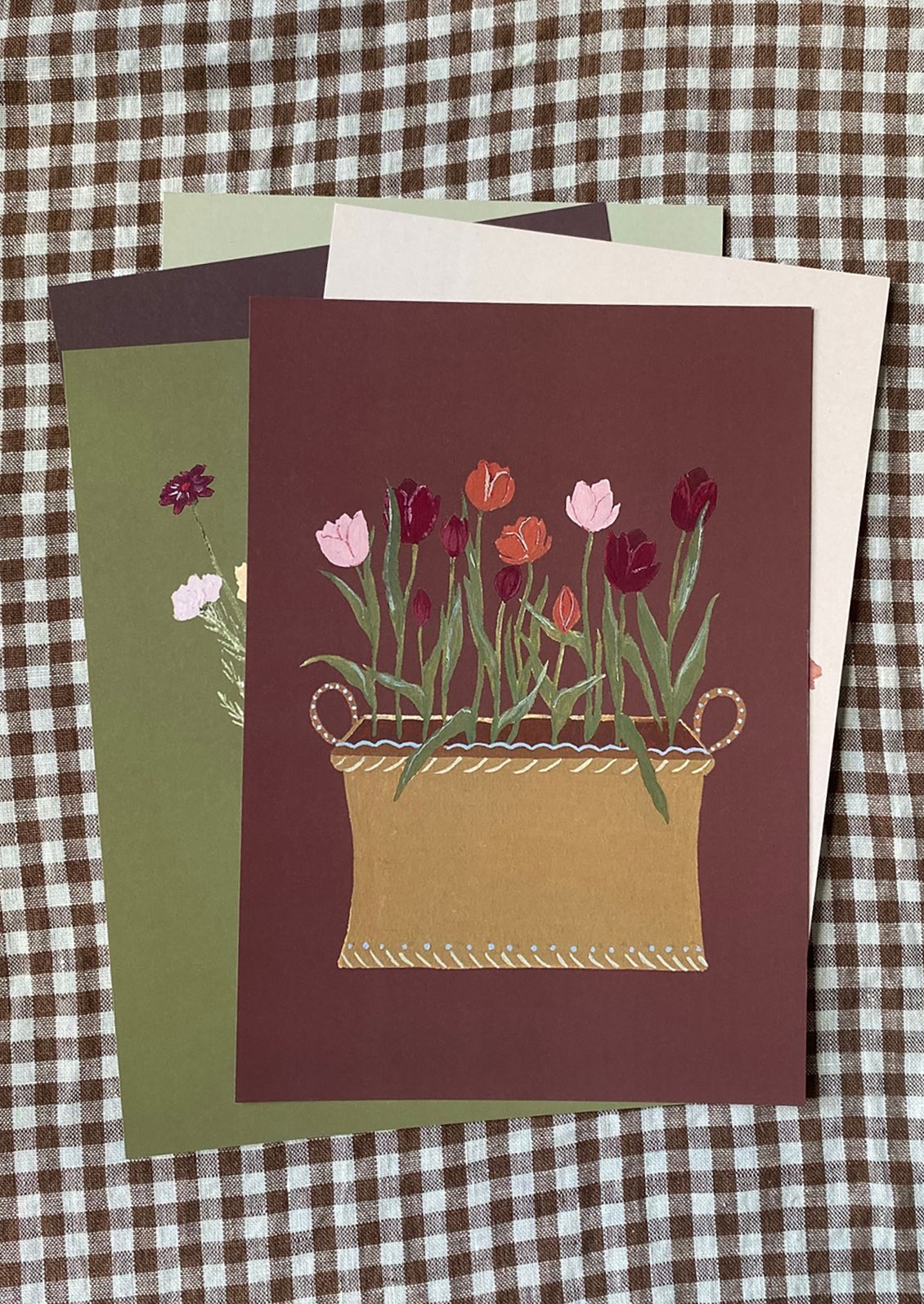 An illustrated art print of tulips in planter box on dark burgundy background.