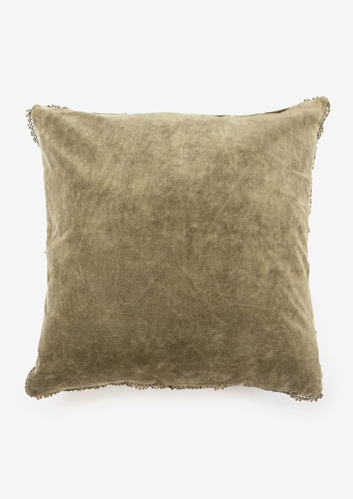 A velvet throw pillow with pom pom trim in olive color.