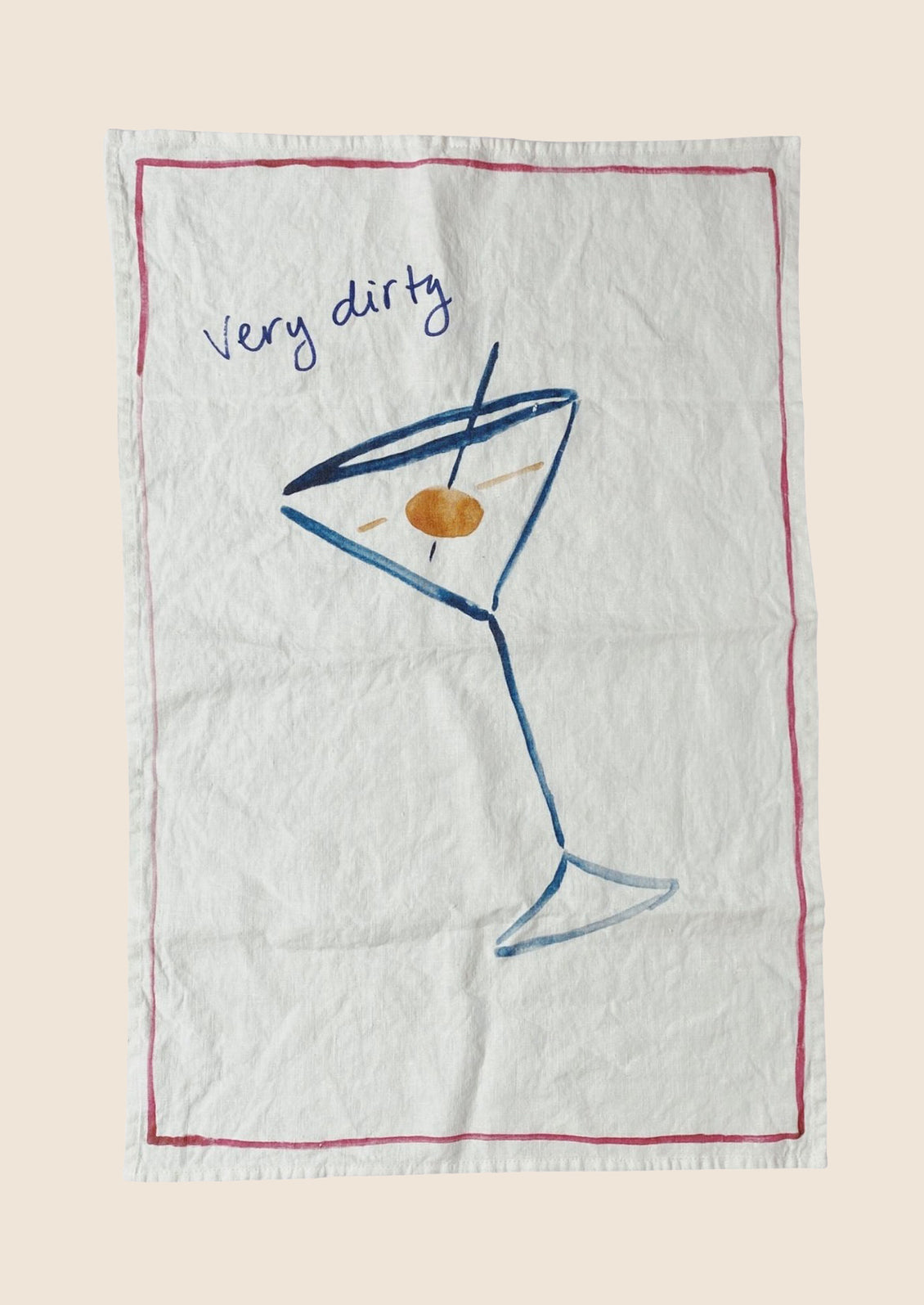 A white linen tea towel with Very Dirty Martini graphic and text.