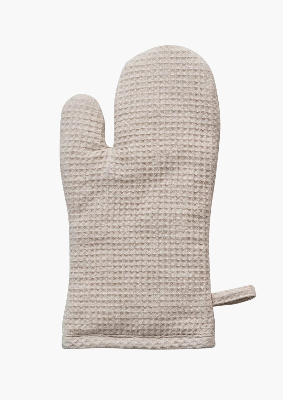 A waffle textured cotton oven mitt in cream.