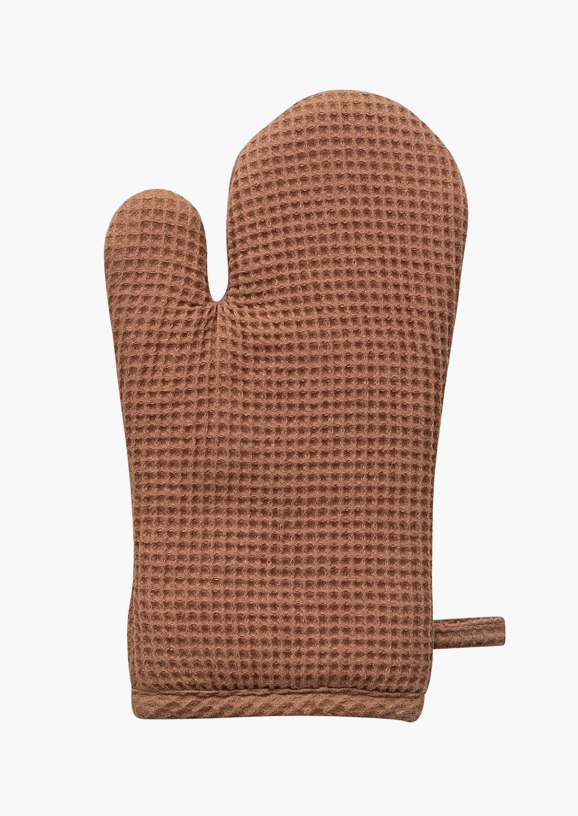 A waffle textured cotton oven mitt in terracotta.