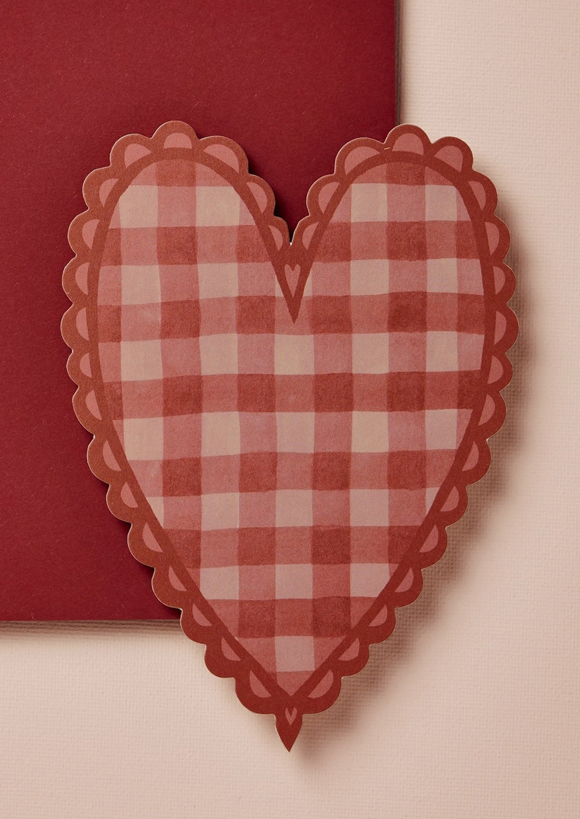 A heart shaped card in red gingham print.