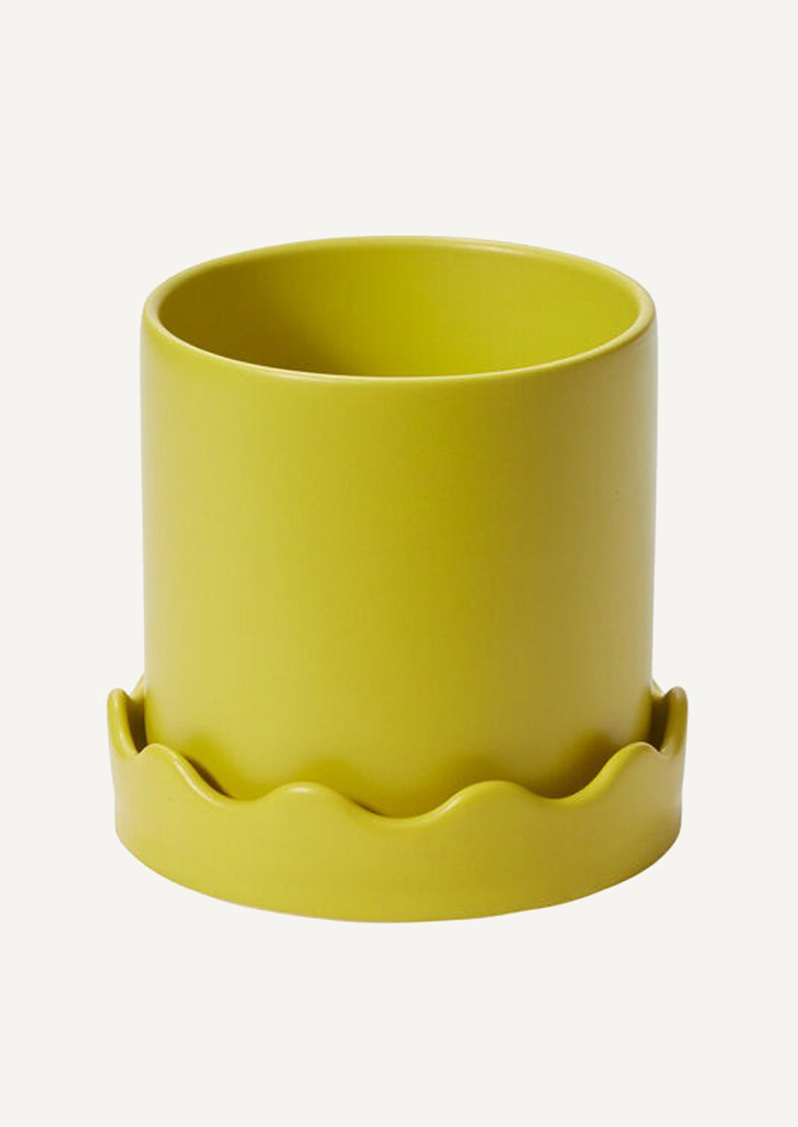 A planter in chartreuse ceramic with matching wavy edge saucer.