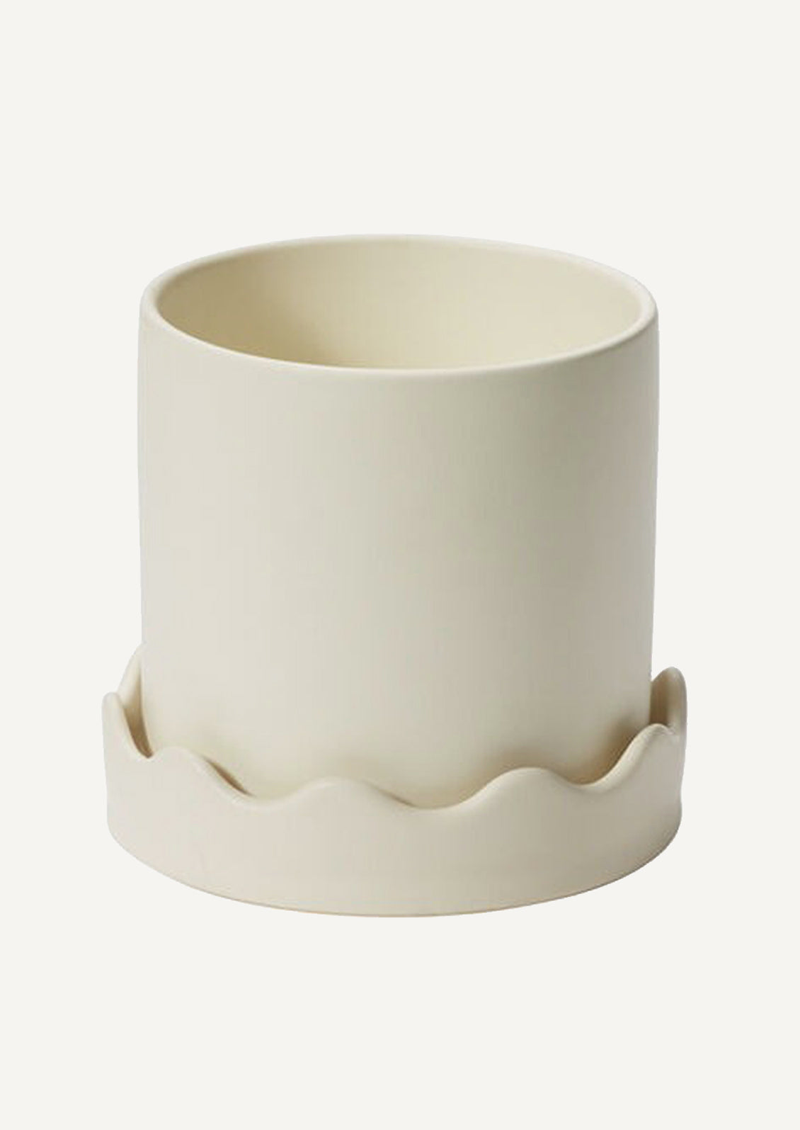 A planter in chartreuse ceramic with matching wavy edge saucer.