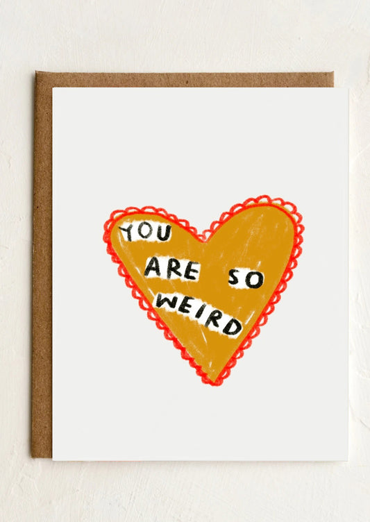 A card with heart shape drawing reading "You are so weird".