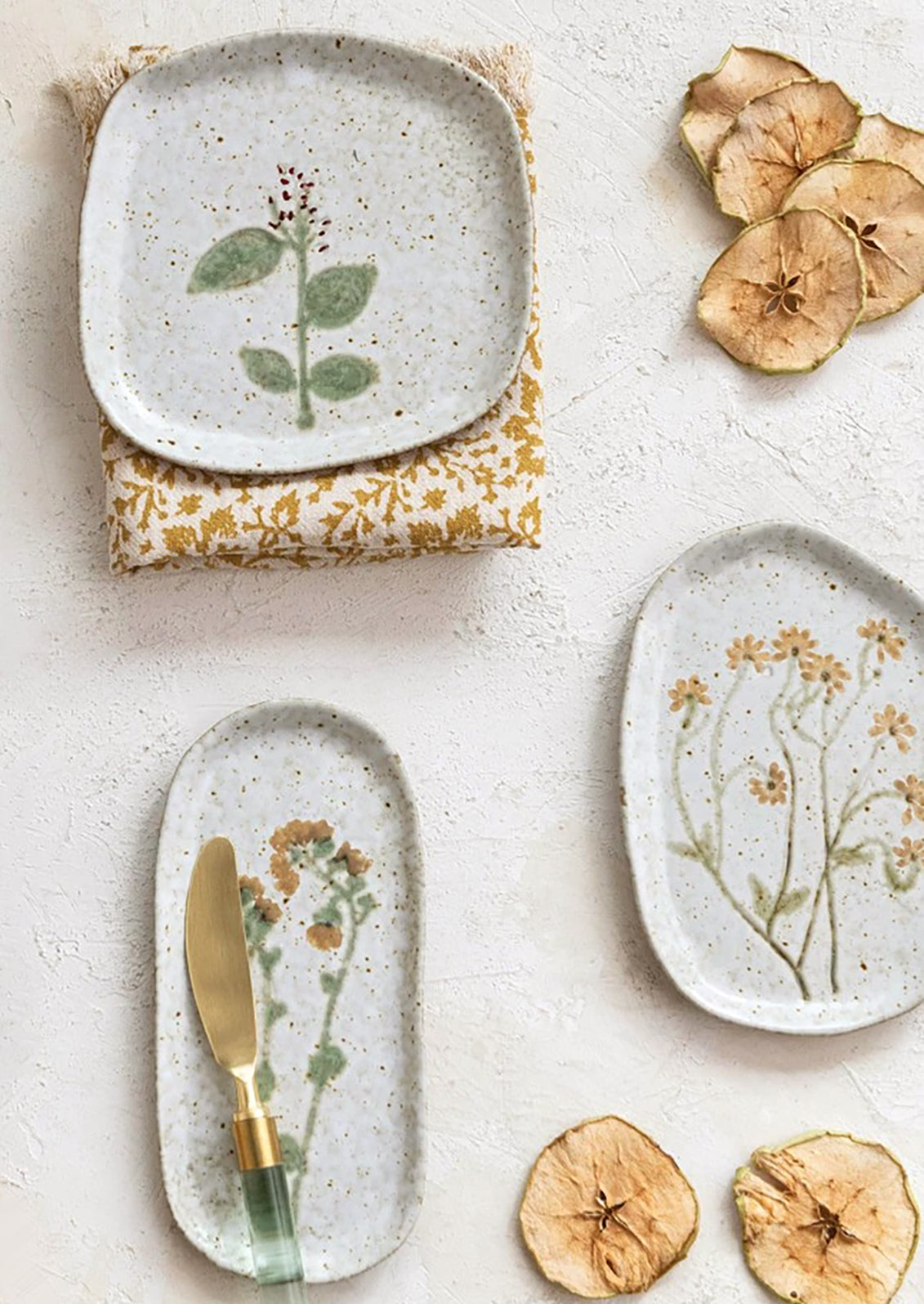 Ceramic plates in asymmetrical shapes with wildflower patterns.