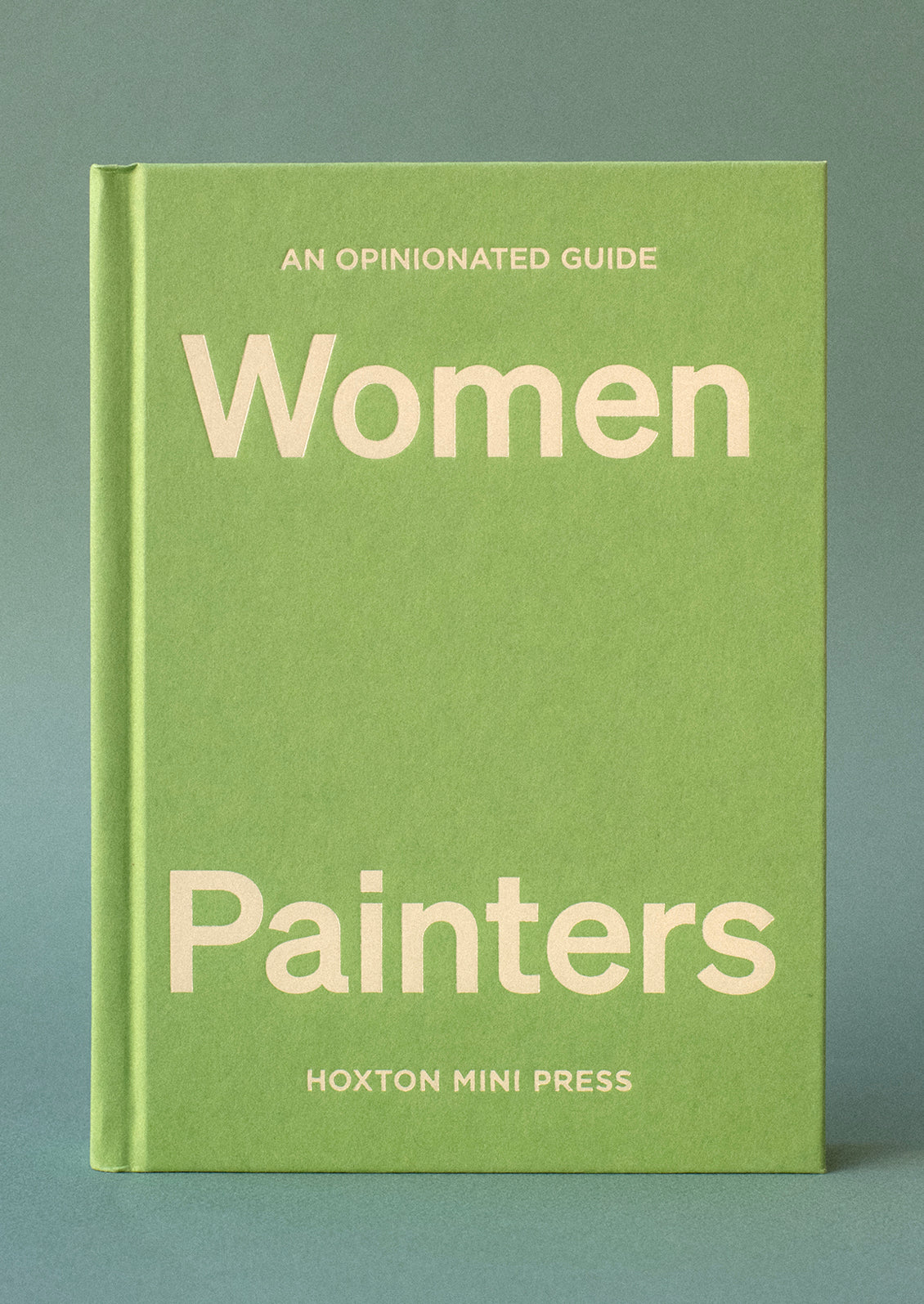 A green hardcover book with yellow lettering titled "An Opinionated Guide To Women Painters".